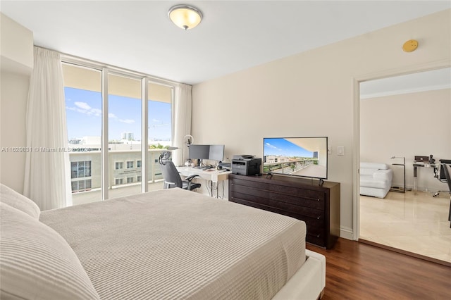 bedroom featuring hardwood / wood-style floors, access to outside, and crown molding