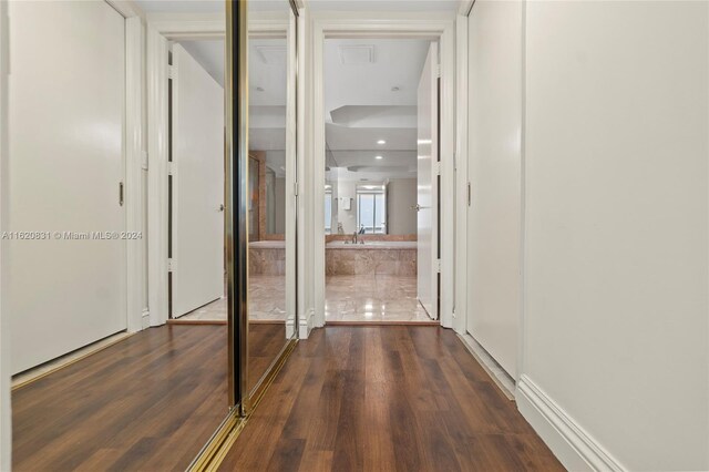 corridor featuring dark hardwood / wood-style floors