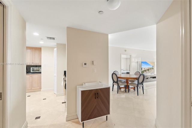 kitchen featuring light brown cabinets and light tile patterned floors