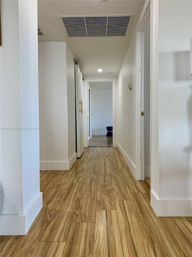 hall with light hardwood / wood-style flooring