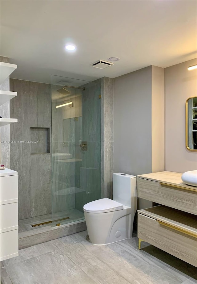 bathroom with vanity, toilet, and walk in shower