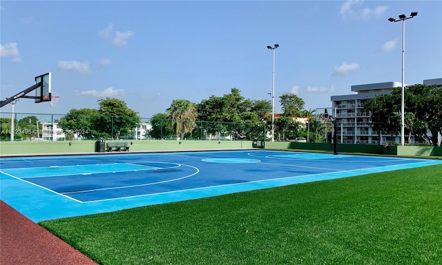 view of sport court featuring a yard