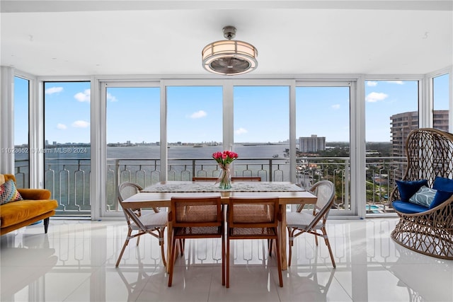 sunroom with a water view and plenty of natural light