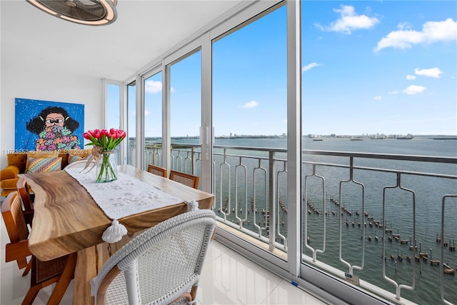 sunroom / solarium featuring a water view