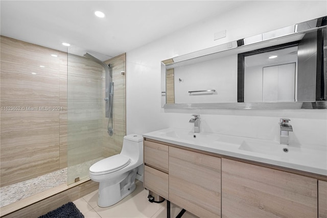 bathroom featuring a walk in shower, a sink, toilet, and double vanity