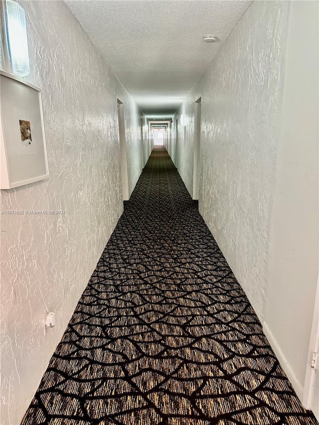 hallway with a textured ceiling