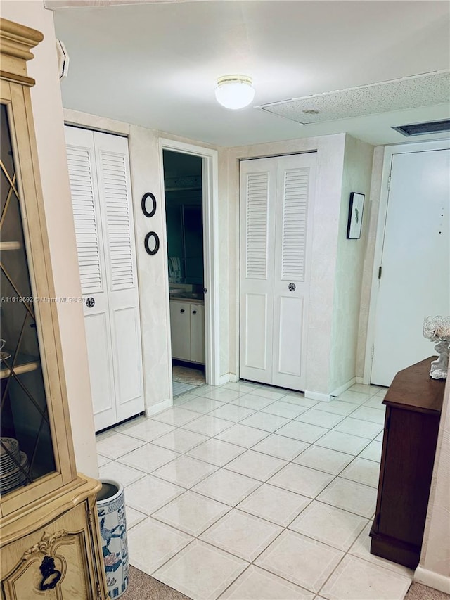 hallway featuring light tile patterned flooring