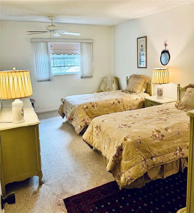 carpeted bedroom with ceiling fan and a textured ceiling