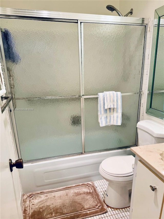 full bathroom with vanity, tile patterned floors, shower / bath combination with glass door, and toilet