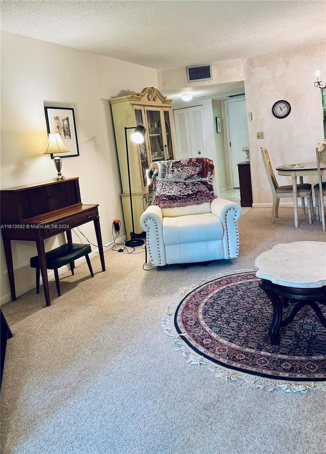 living room with light colored carpet and a textured ceiling