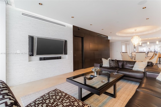 living room with a notable chandelier and a raised ceiling