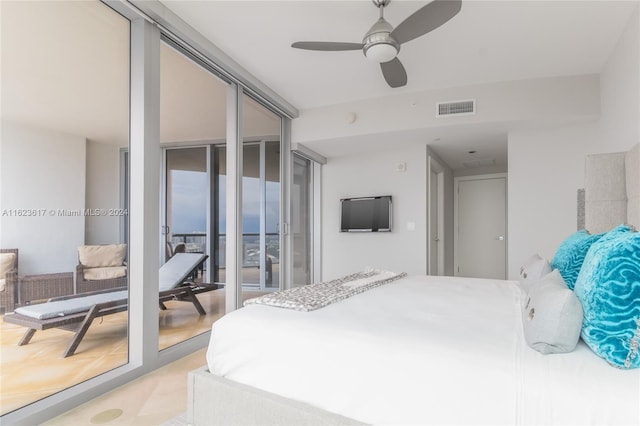 bedroom featuring a wall of windows and ceiling fan