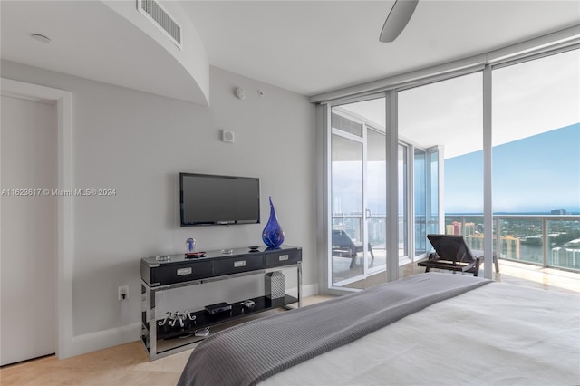 bedroom with a wall of windows, access to exterior, and ceiling fan