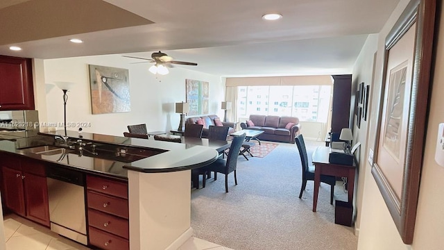 kitchen with dishwasher, ceiling fan, light colored carpet, sink, and kitchen peninsula