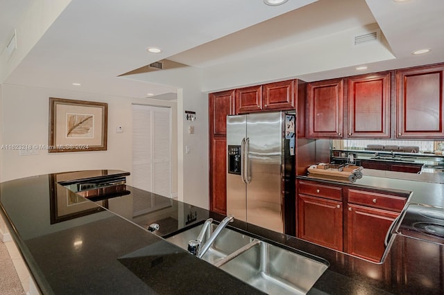 kitchen featuring sink and stainless steel fridge with ice dispenser