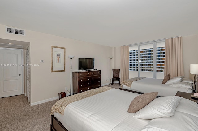 bedroom featuring light colored carpet