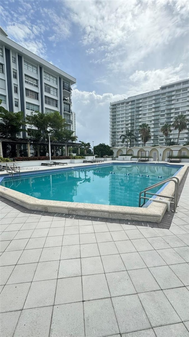 view of swimming pool featuring a patio area