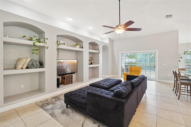 living room featuring built in features, ceiling fan, and light tile patterned flooring