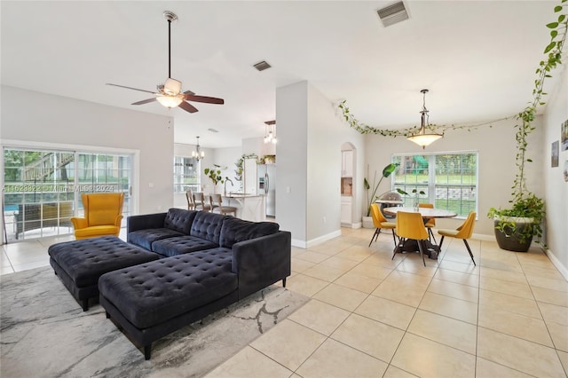 tiled living room with ceiling fan