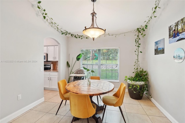 dining area with light tile patterned flooring