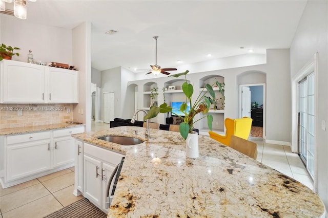 kitchen with plenty of natural light, sink, and white cabinetry