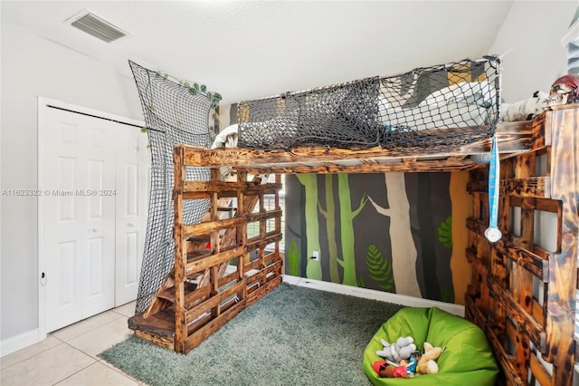 bedroom featuring a closet and tile patterned flooring