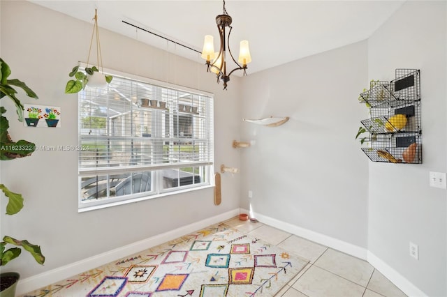 dining room featuring a notable chandelier and light tile patterned floors