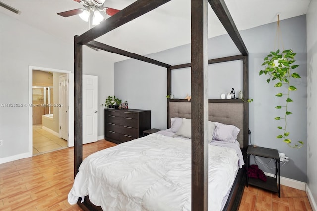 bedroom with ensuite bathroom, light hardwood / wood-style flooring, and ceiling fan