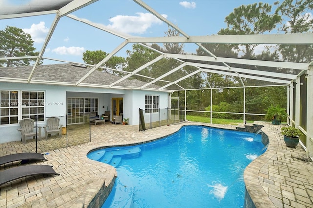 view of swimming pool with a lanai, pool water feature, and a patio area