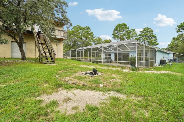 view of yard with glass enclosure