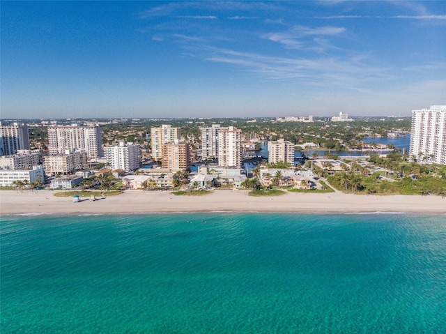 birds eye view of property with a city view, a beach view, and a water view