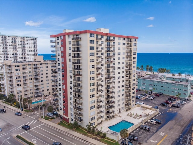 view of property featuring a water view and uncovered parking