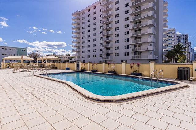 view of pool with a patio and central AC