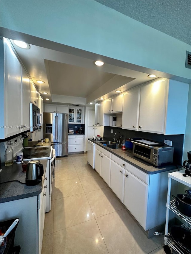 1501 S Ocean Dr Unit 201, Hollywood, FL 33019 - kitchen featuring stainless steel fridge with ice dispenser, electric stove, dark countertops, a sink, and white cabinets