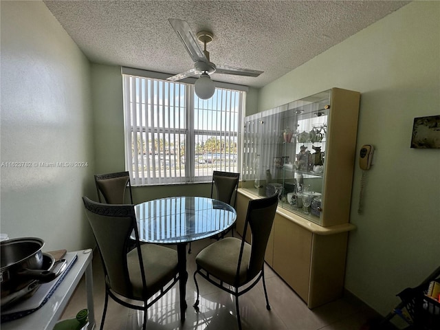 dining room featuring a textured ceiling and ceiling fan