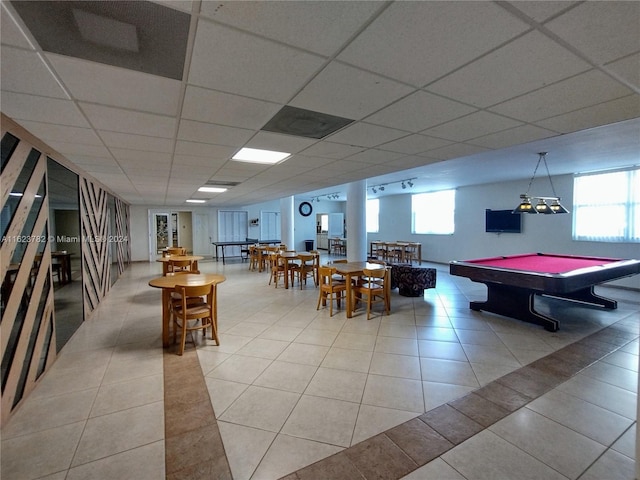 rec room featuring pool table, a drop ceiling, light tile patterned floors, and a wealth of natural light