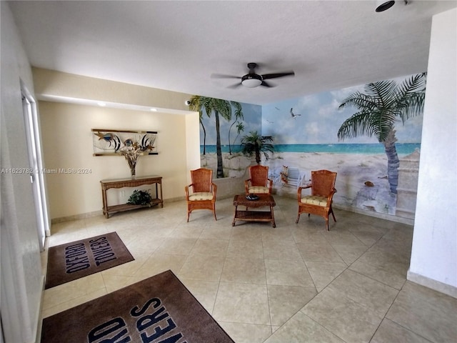 sitting room featuring ceiling fan and light tile patterned floors