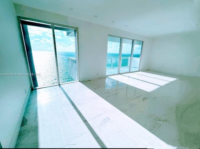 unfurnished room with a water view