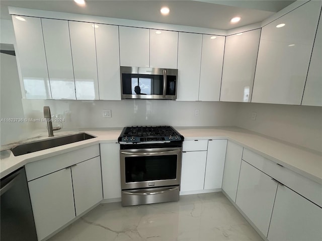 2030 S Ocean Dr Unit 2220, Hallandale Beach, FL 33009 - kitchen with appliances with stainless steel finishes, a sink, light marble finish floors, white cabinetry, and recessed lighting
