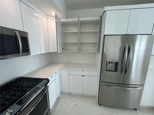 kitchen featuring stainless steel appliances and white cabinets