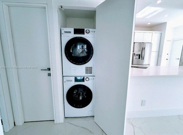 laundry area featuring stacked washer and clothes dryer