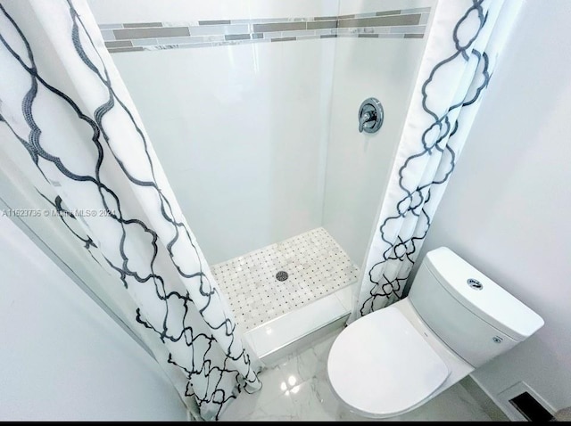 bathroom with a shower with curtain and toilet