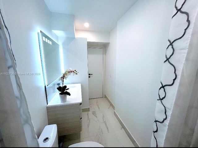 2030 S Ocean Dr Unit 2220, Hallandale Beach, FL 33009 - bathroom featuring marble finish floors, toilet, vanity, and baseboards