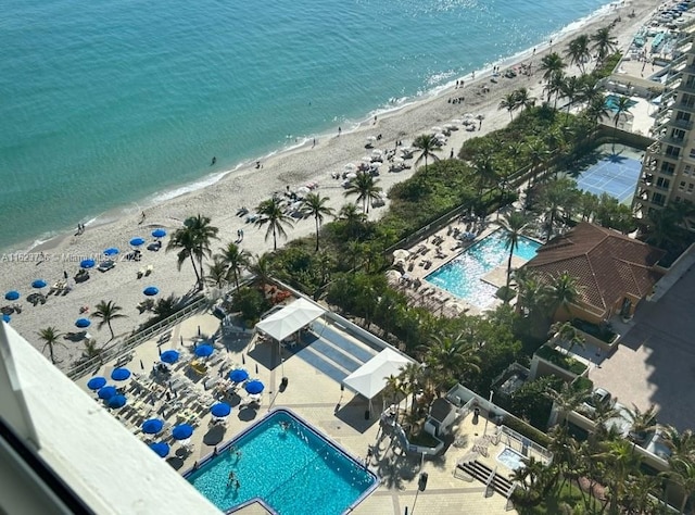 bird's eye view with a water view and a beach view