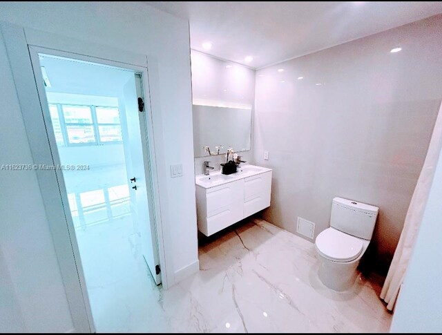 bathroom featuring vanity and toilet