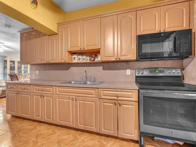 kitchen featuring stainless steel electric range, sink, light brown cabinetry, and tasteful backsplash