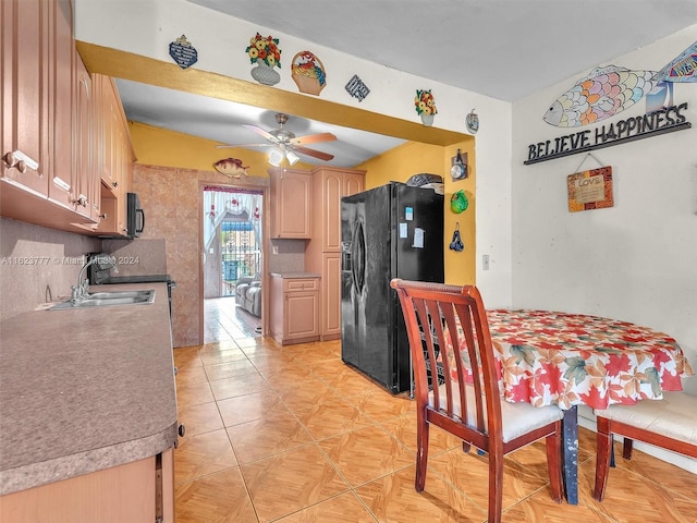 kitchen featuring ceiling fan, light brown cabinets, black refrigerator with ice dispenser, sink, and backsplash