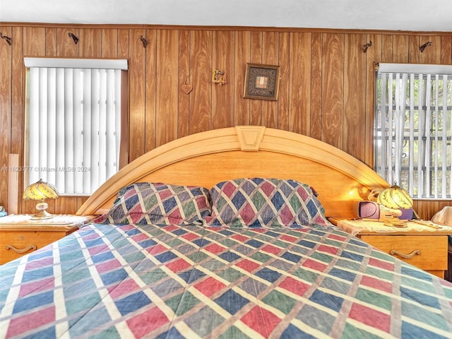 bedroom featuring wood walls