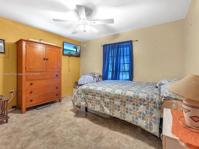 tiled bedroom featuring ceiling fan