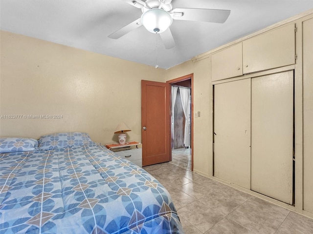 tiled bedroom featuring a closet and ceiling fan